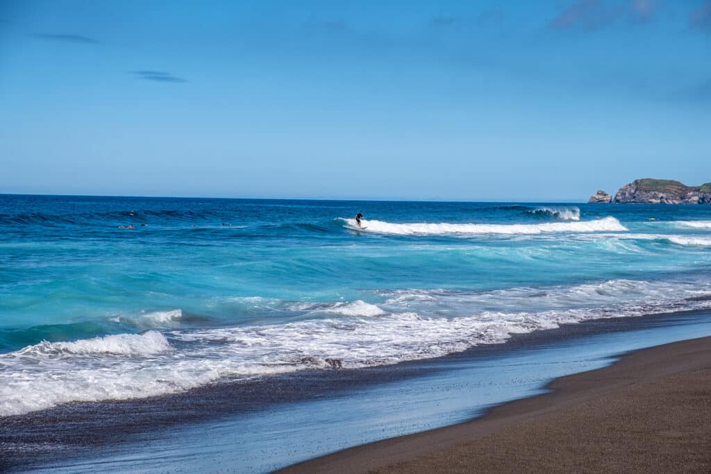 Beautiful landscape surfers riding a wave on Santa Barbara Beach